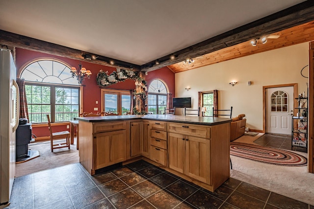 309A Cushman Rd, Woodstock, ME 04219 - kitchen featuring dark countertops, beamed ceiling, healthy amount of natural light, and freestanding refrigerator