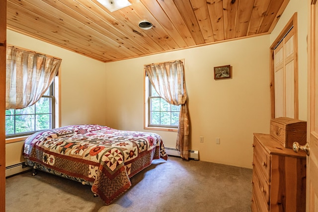 309A Cushman Rd, Woodstock, ME 04219 - carpeted bedroom featuring a baseboard heating unit, multiple windows, and wooden ceiling