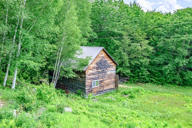 309A Cushman Rd, Woodstock, ME 04219 - view of outdoor structure featuring a wooded view