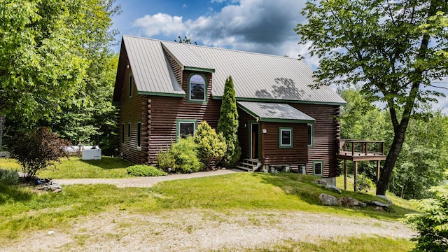 309A Cushman Rd, Woodstock, ME 04219 - view of front facade with log siding, a metal roof, a front lawn, and a wooden deck
