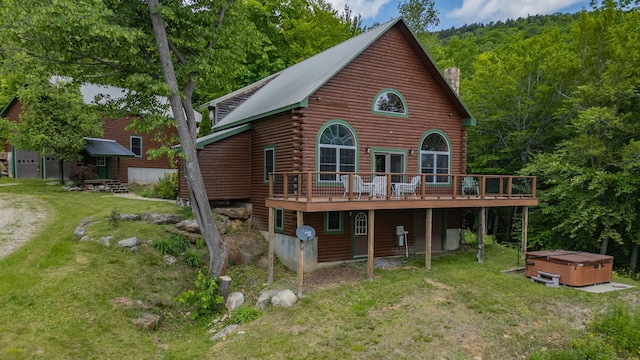 309A Cushman Rd, Woodstock, ME 04219 - rear view of house featuring a hot tub, a wooden deck, log exterior, a yard, and a chimney