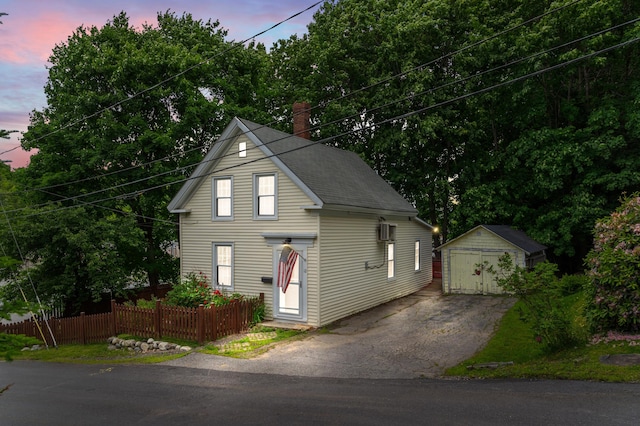 12 Robinson St, Gardiner, ME 04345 - view of front of home featuring a detached garage, an outdoor structure, and a chimney