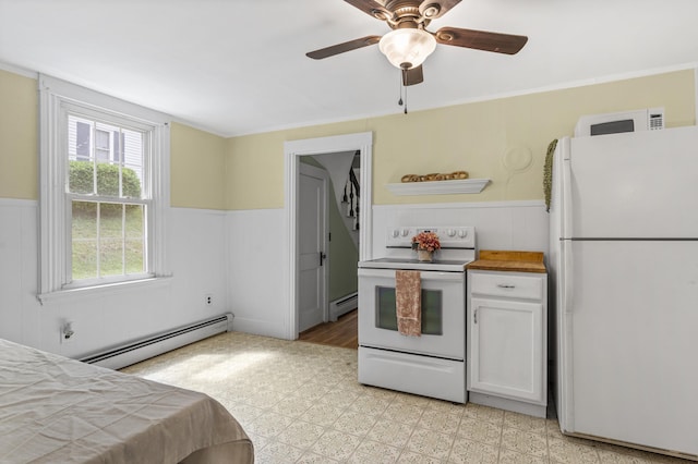 12 Robinson St, Gardiner, ME 04345 - kitchen featuring white appliances, baseboard heating, wainscoting, a ceiling fan, and light flooring