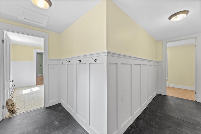 12 Robinson St, Gardiner, ME 04345 - hallway with a baseboard radiator, a wainscoted wall, attic access, and a decorative wall