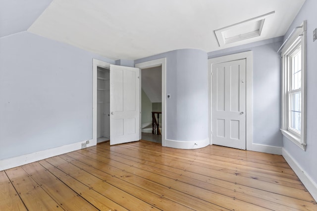 12 Robinson St, Gardiner, ME 04345 - unfurnished bedroom featuring a closet, light wood-type flooring, and attic access