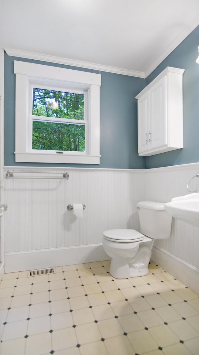 326 Meetinghouse Rd, Wells, ME 04090 - bathroom with a wainscoted wall, ornamental molding, and tile patterned floors