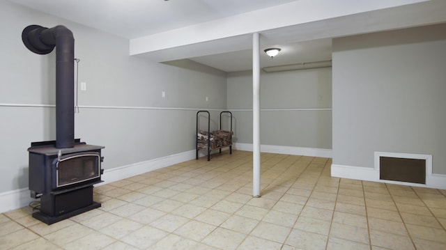 326 Meetinghouse Rd, Wells, ME 04090 - finished below grade area featuring a wood stove and baseboards