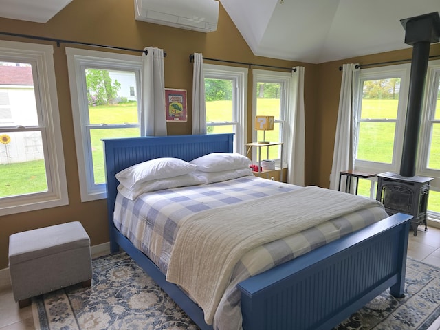 135 Hotel Rd, Auburn, ME 04210 - tiled bedroom featuring a wood stove and vaulted ceiling