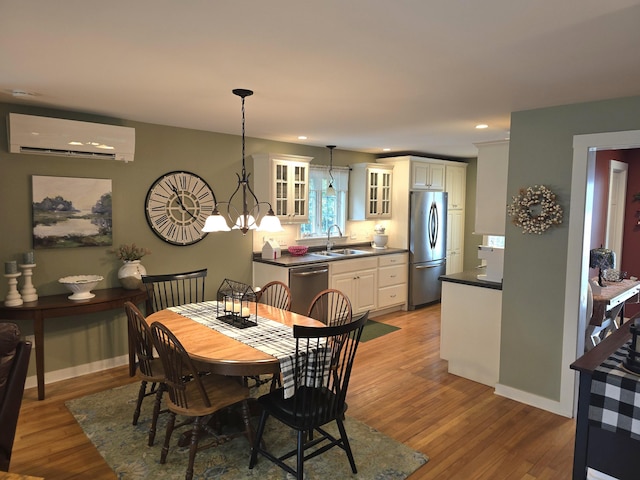 135 Hotel Rd, Auburn, ME 04210 - dining area featuring a wall mounted air conditioner, light wood-style floors, recessed lighting, and a chandelier