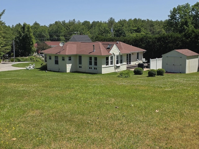 135 Hotel Rd, Auburn, ME 04210 - rear view of property with a storage unit, a lawn, and a wooded view