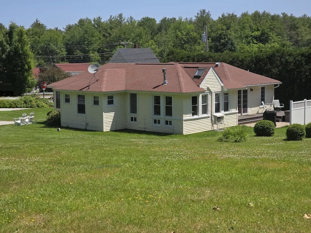 135 Hotel Rd, Auburn, ME 04210 - back of house with a lawn, a wooded view, and a shingled roof