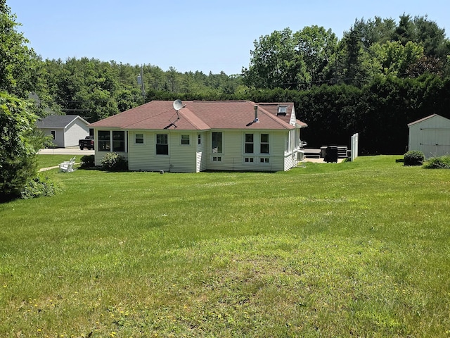 135 Hotel Rd, Auburn, ME 04210 - rear view of house featuring a lawn and a storage shed