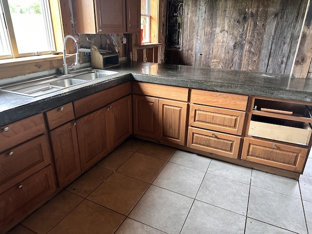754 US Route 1, Weston, ME 04424 - kitchen with light tile patterned flooring, dark countertops, brown cabinetry, and wood walls