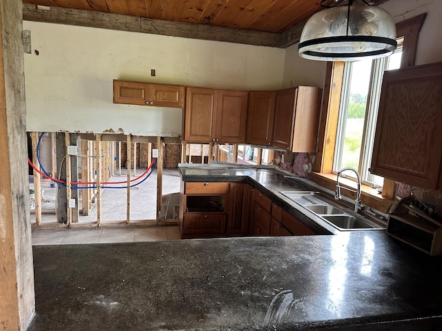 754 US Route 1, Weston, ME 04424 - kitchen featuring wood ceiling, dark countertops, tile patterned flooring, and brown cabinets
