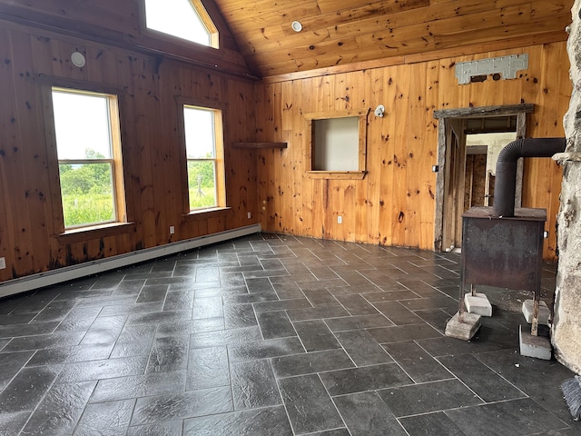 754 US Route 1, Weston, ME 04424 - empty room with healthy amount of natural light, a baseboard radiator, a wood stove, lofted ceiling, and wooden walls
