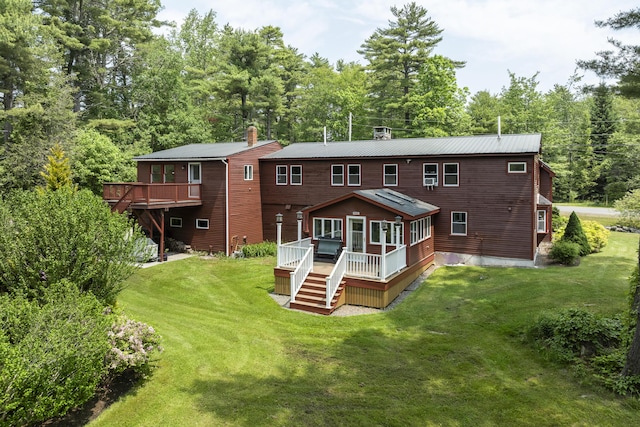 11 Everett Dow Dr, Woolwich, ME 04579 - back of property with a deck, stairway, and a yard