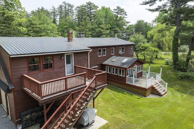 11 Everett Dow Dr, Woolwich, ME 04579 - back of property featuring stairs, a chimney, a deck, a lawn, and a metal roof