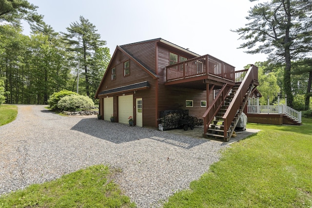 11 Everett Dow Dr, Woolwich, ME 04579 - rear view of house with stairway, a wooden deck, a garage, and gravel driveway