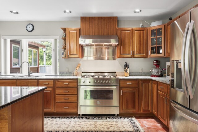 11 Everett Dow Dr, Woolwich, ME 04579 - kitchen featuring stainless steel appliances, exhaust hood, light stone counters, brown cabinets, and recessed lighting