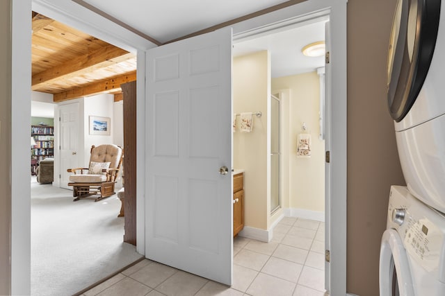11 Everett Dow Dr, Woolwich, ME 04579 - laundry room featuring stacked washing machine and dryer, light tile patterned floors, and wooden ceiling