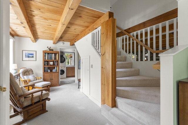 11 Everett Dow Dr, Woolwich, ME 04579 - sitting room featuring stacked washer / drying machine, carpet, stairs, and a wooden ceiling with exposed beams
