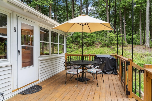 8 N Lakeview Dr, Litchfield, ME 04350 - wooden terrace featuring outdoor dining space and a grill