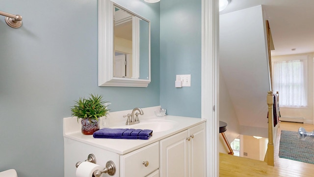 1 Daniels Way, Falmouth, ME 04105 - bathroom with healthy amount of natural light, baseboard heating, vanity, and wood finished floors