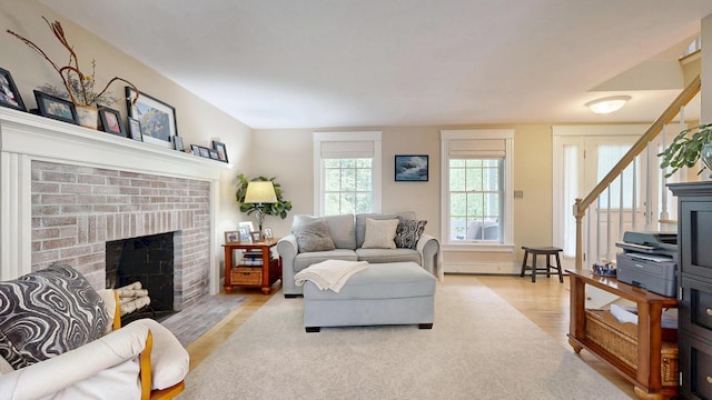 1 Daniels Way, Falmouth, ME 04105 - living area with light wood-type flooring, a fireplace, and baseboard heating