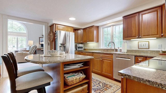 1 Daniels Way, Falmouth, ME 04105 - kitchen with stainless steel appliances, a kitchen bar, brown cabinetry, recessed lighting, and a kitchen island