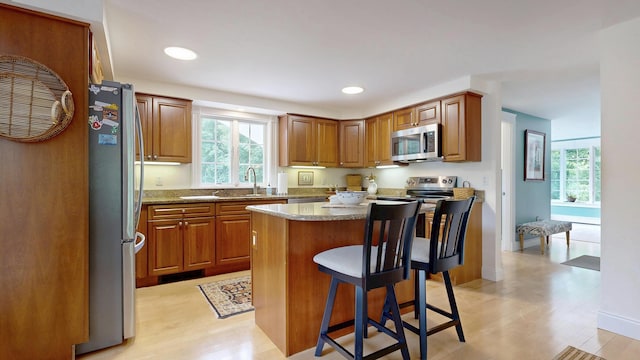 1 Daniels Way, Falmouth, ME 04105 - kitchen with stainless steel appliances, plenty of natural light, a breakfast bar, a center island, and recessed lighting