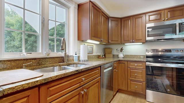 1 Daniels Way, Falmouth, ME 04105 - kitchen featuring stainless steel appliances, brown cabinets, and light stone counters