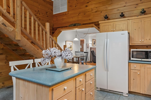 19 Fox Ln, Bremen, ME 04551 - kitchen featuring white appliances, light brown cabinets, wooden walls, a kitchen island, and decorative light fixtures
