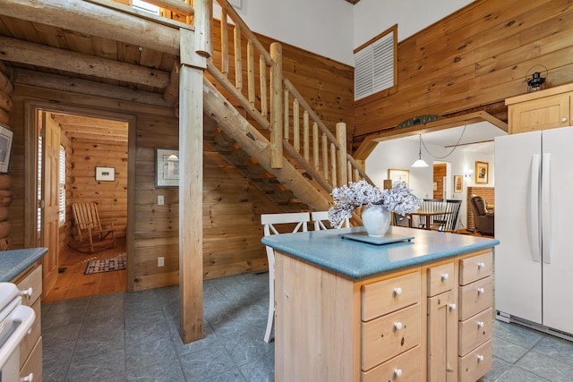 19 Fox Ln, Bremen, ME 04551 - kitchen with freestanding refrigerator, light brown cabinets, stove, wooden walls, and a center island