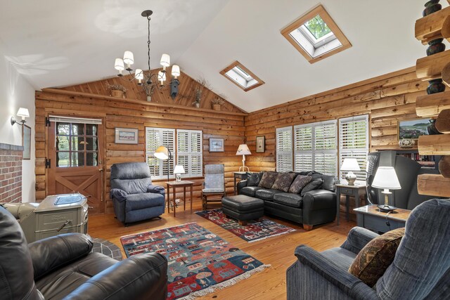 19 Fox Ln, Bremen, ME 04551 - living area with a skylight, rustic walls, lofted ceiling, a chandelier, and wood finished floors