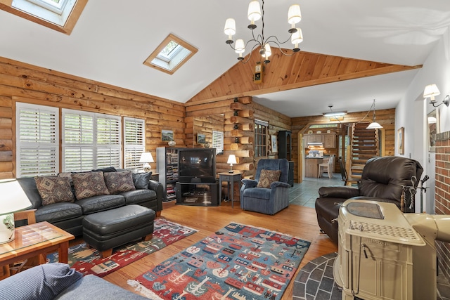 19 Fox Ln, Bremen, ME 04551 - living room featuring rustic walls, a skylight, vaulted ceiling, wood finished floors, and a chandelier