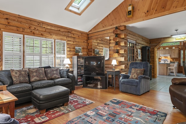 19 Fox Ln, Bremen, ME 04551 - living room featuring log walls, a skylight, wood-type flooring, and high vaulted ceiling
