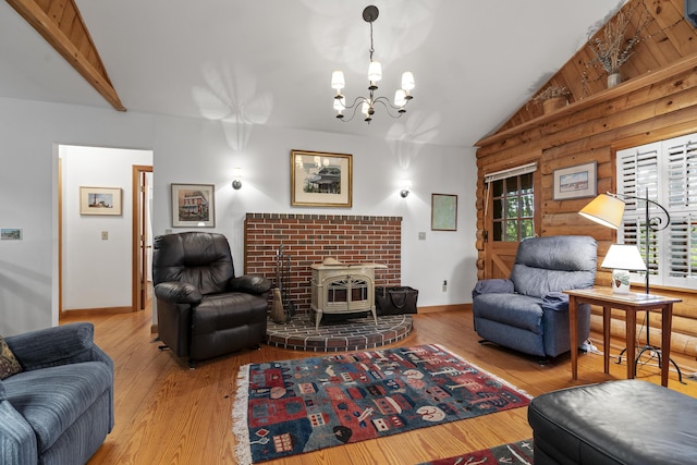 19 Fox Ln, Bremen, ME 04551 - living area with vaulted ceiling, a wood stove, wood finished floors, and a chandelier
