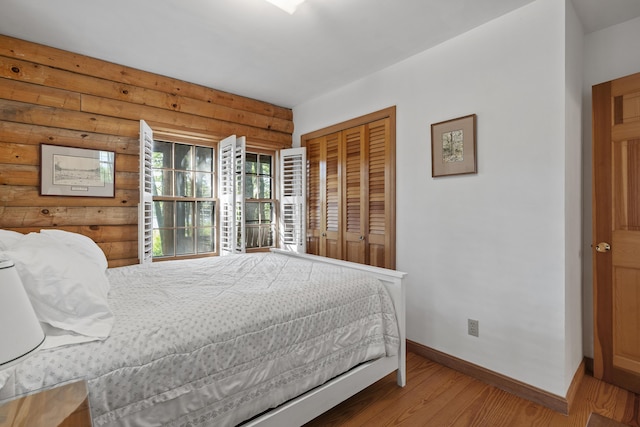 19 Fox Ln, Bremen, ME 04551 - bedroom with log walls, wood finished floors, and a closet