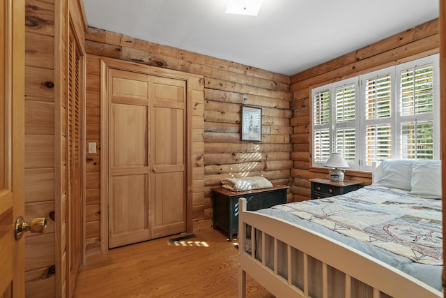 19 Fox Ln, Bremen, ME 04551 - bedroom featuring rustic walls and light wood-style flooring