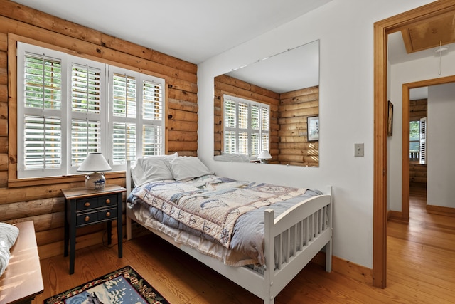 19 Fox Ln, Bremen, ME 04551 - bedroom with rustic walls, attic access, and wood-type flooring