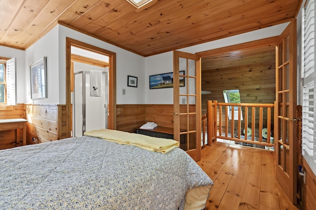 19 Fox Ln, Bremen, ME 04551 - bedroom with wooden walls, light wood-style flooring, a wainscoted wall, wooden ceiling, and multiple windows