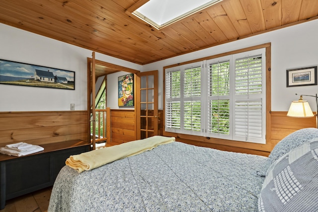 19 Fox Ln, Bremen, ME 04551 - bedroom with a skylight, wainscoting, wood ceiling, wood finished floors, and wooden walls