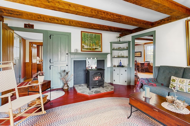 351 Mill Creek Rd, Islesboro, ME 04848 - living area featuring beam ceiling, wood finished floors, and a wood stove