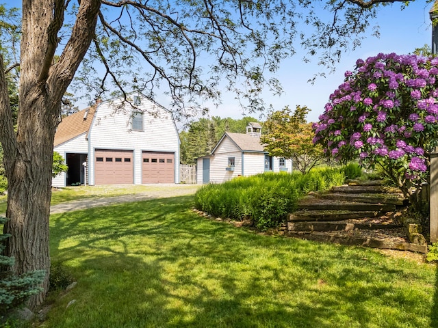 351 Mill Creek Rd, Islesboro, ME 04848 - view of front of property with an outbuilding, a gambrel roof, a front lawn, a garage, and driveway