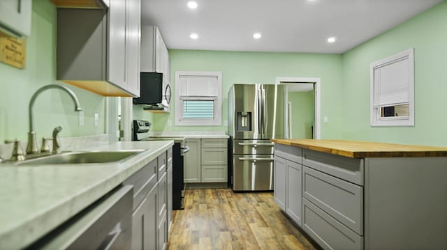 15 Goodwin St, Sanford, ME 04083 - kitchen with appliances with stainless steel finishes, butcher block counters, gray cabinets, light wood-style flooring, and recessed lighting