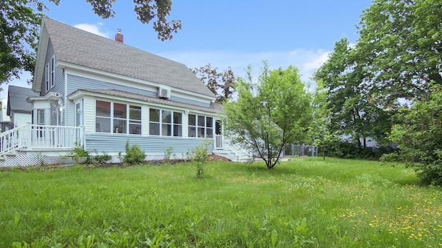 15 Goodwin St, Sanford, ME 04083 - back of house with roof with shingles, a chimney, a sunroom, and a deck