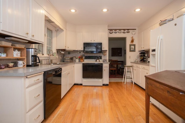 3 Fenderson Hill N, Wilton, ME 04294 - kitchen featuring black appliances, white cabinetry, light countertops, light wood-style floors, and recessed lighting