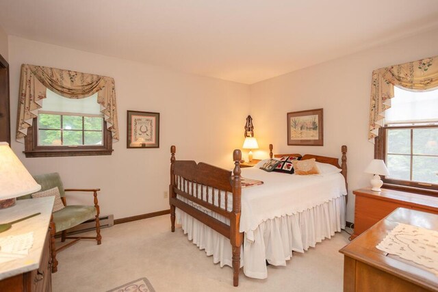 3 Fenderson Hill N, Wilton, ME 04294 - bedroom with multiple windows, light colored carpet, and a baseboard radiator