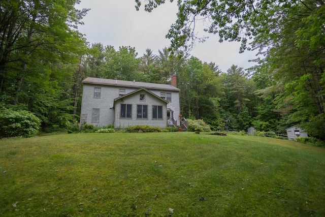 3 Fenderson Hill N, Wilton, ME 04294 - view of front facade with a chimney, a front lawn, and a forest view
