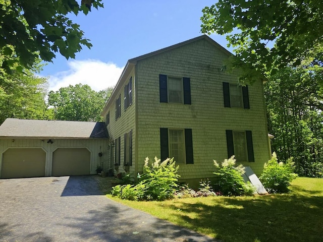 3 Fenderson Hill N, Wilton, ME 04294 - view of front of house with an attached garage, asphalt driveway, and a front yard